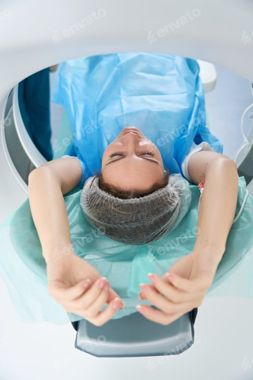Preview: Woman is placed in tomography camera at a medical center