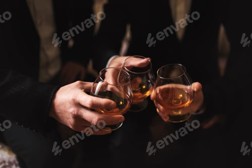 Preview: Business meeting. Men hold glasses of whiskey. Men's Party. Hand with a drink of alcohol
