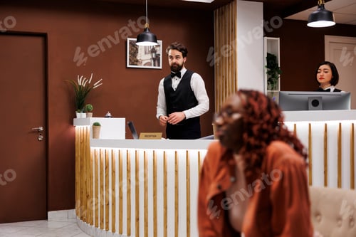 Preview: Hotel receptionist working at front desk