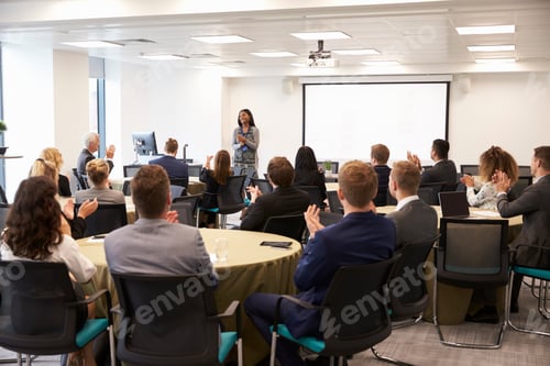 Preview: Delegates Applauding Businesswoman Making Presentation