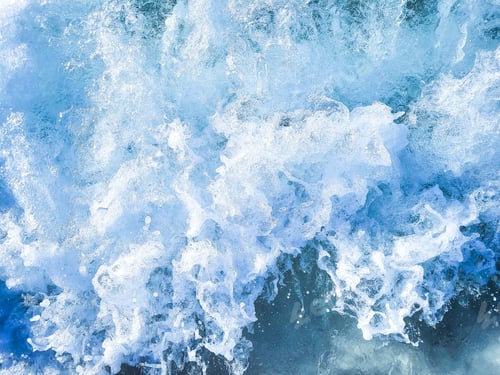 Preview: Blue sea as ocean wave hits shoreline.