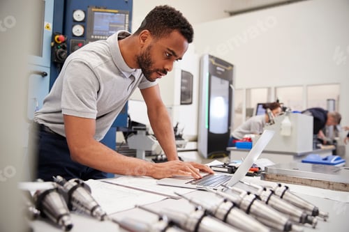 Preview: Male Engineer Using CAD Programming Software On Laptop