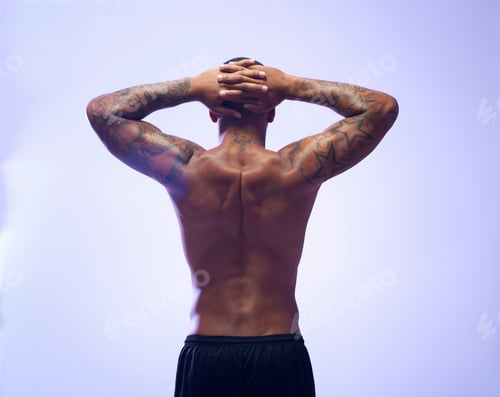 Preview: Rear view studio shot of muscular young sportsman with hands behind head