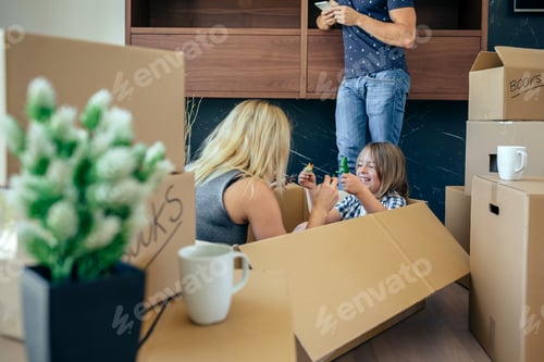 Preview: Mother and son playing while father looks the mobile