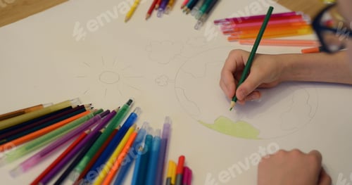 Preview: Child boy draws planet for earth day. Protection of enviroment, Mother Earth Day. Save our planet