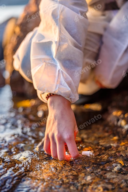 Preview: Close-up of scientist collecting water sample at seashore