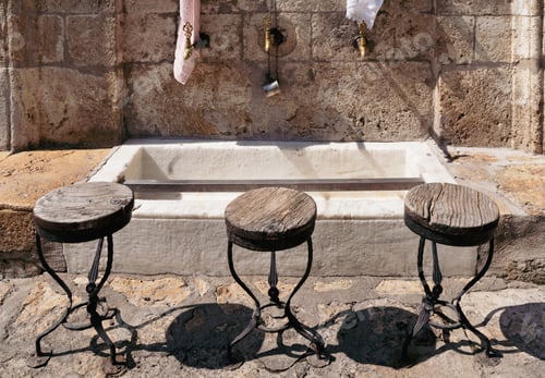 Preview: closeup of bronze water faucets near a Muslim mosque