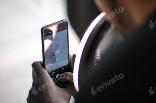 Preview: artisan sweet designer photographing a bloody halloween cake isolated on white
