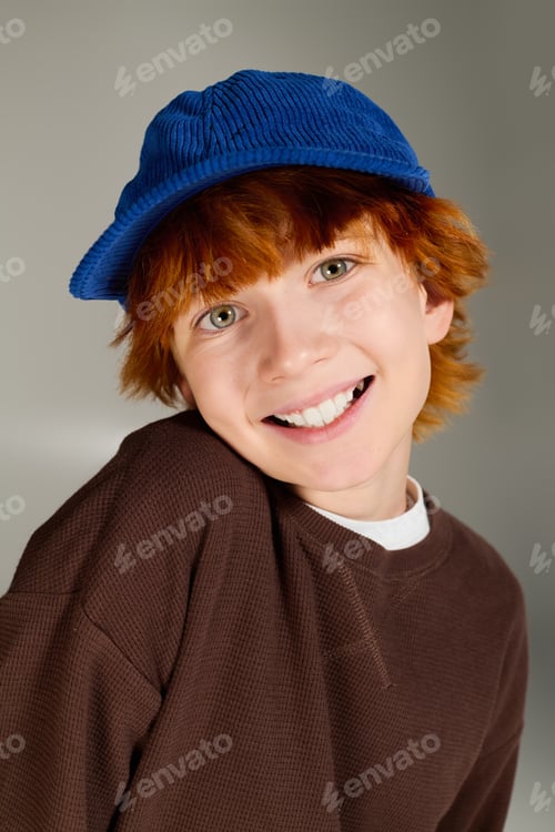 Preview: Creative fashion display with a redhead boy in a stylish studio setting