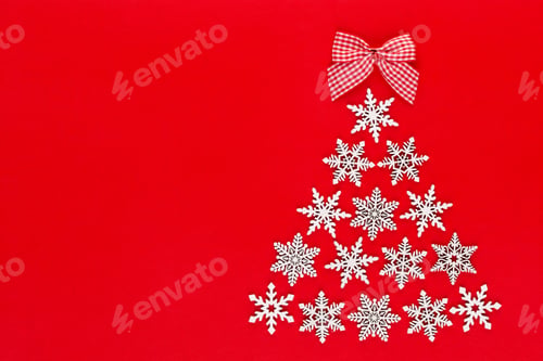 Preview: White snow flake decoration on red background. Flat lay, top view