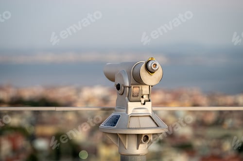 Preview: Viewing platform telescope overlooking a city at sunset near a waterfront