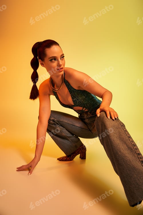 Preview: Young woman in snake print attire poses stylishly, showcasing her makeup and confidence.
