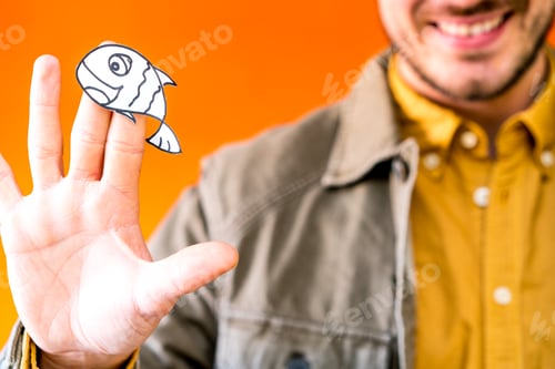 Preview: Smiling man holding funny paper toy