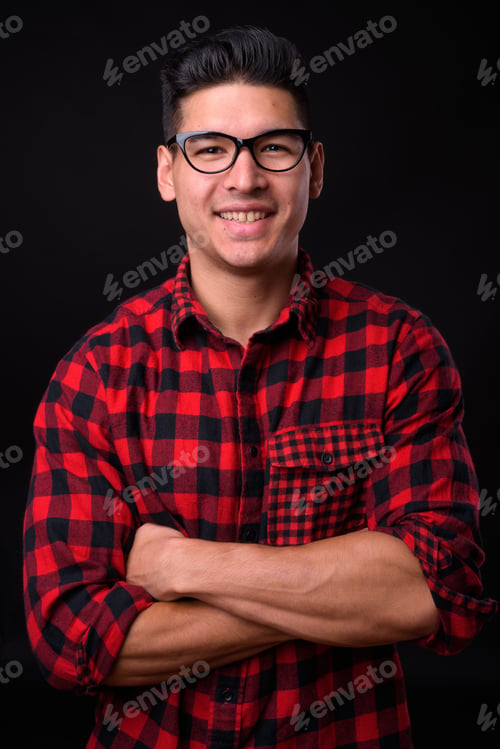 Preview: Young handsome multi-ethnic man against black background