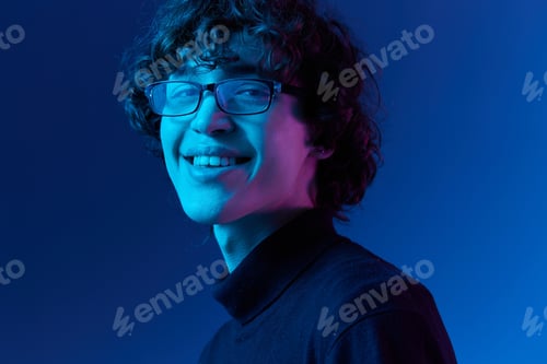 Preview: Man in black sweater model poses in glasses smile, hipster lifestyle, portrait blue background