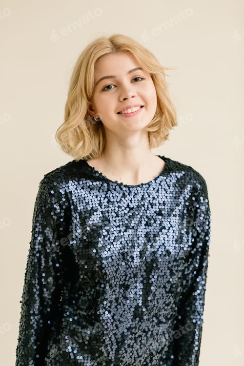 Preview: Luxury female model in a dress with sequins and make-up. Gold Confetti are around