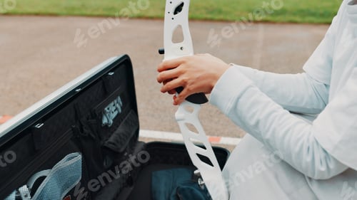 Preview: Woman, hands and prepare for archery training at academy, outdoor exercise and ready bow. Female pe