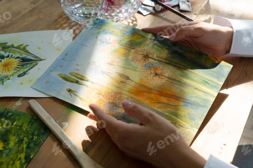 Preview: A Joyful Artist Proudly Showcasing Their Colorful Paint Brushes in a Bright and Inspiring Studio