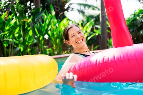 Preview: Woman enjoying the water in a swimming pool
