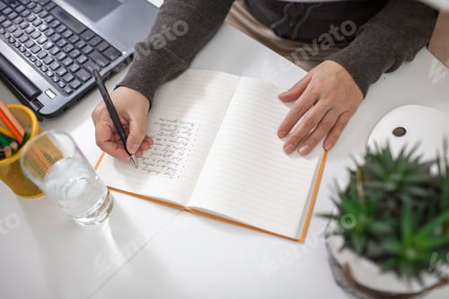 Preview: Woman writing down list of rules for mental health to reduce stress from distant job during lockdown