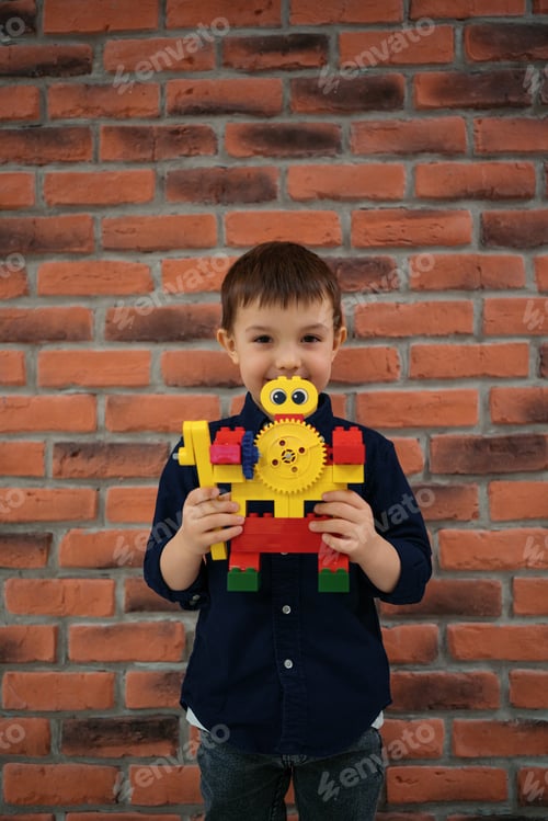 Preview: Boy holding a robot on brick wall background
