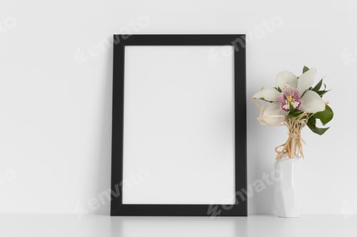 Preview: Black frame mockup with a orchid on the white table.