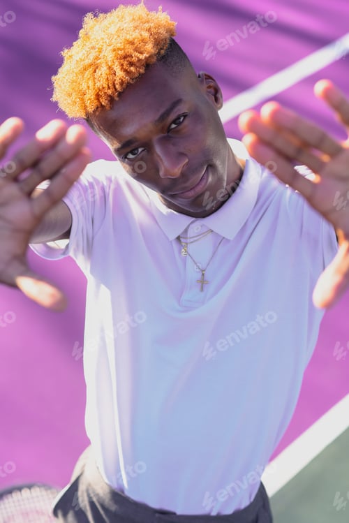 Preview: Portrait of young man making hand gesture