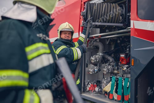 Preview: Mature firefighter training work with fire equipment