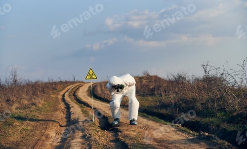Preview: Ecologist standing by biohazard sign and bending over in pain.