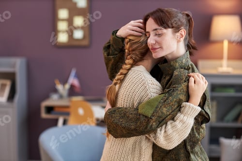 Preview: Side view young military mom embracing daughter with eyes closed