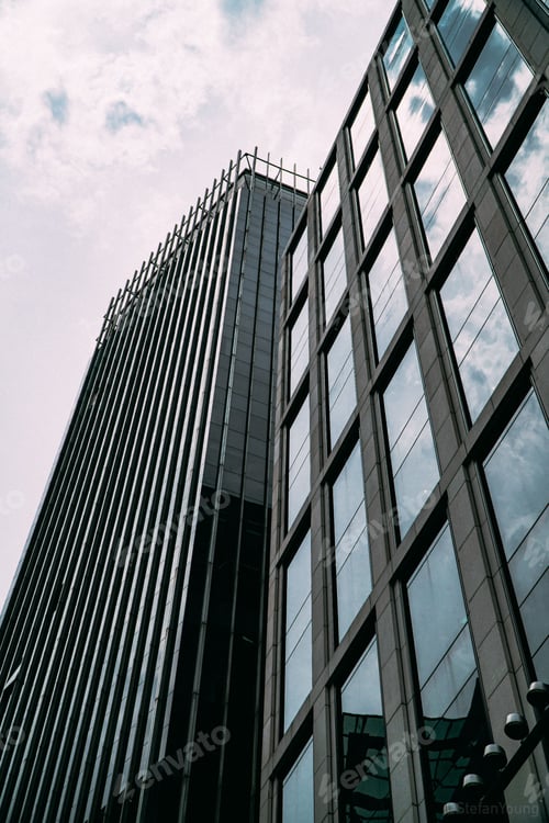 Preview: Low-angle shot of the modern building with glass windows in the city