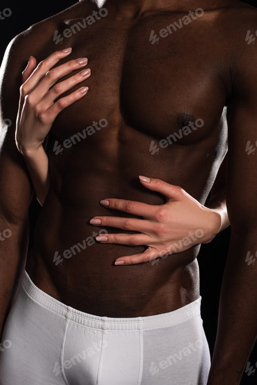 Preview: cropped view of passionate woman hugging african american boyfriend isolated on black