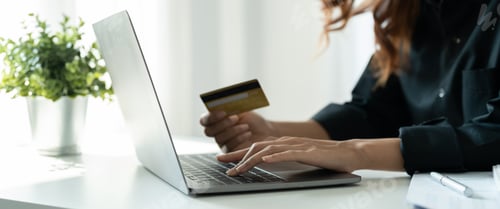 Preview: Young woman holding credit card and using smart phone for online shopping. Online payment shopping