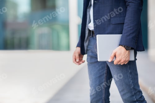 Preview: Cropped of man in formal outfit holding digital tablet
