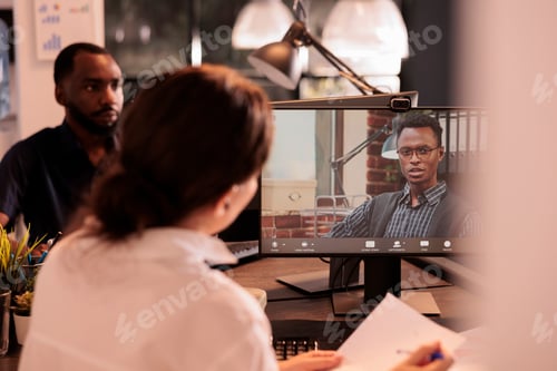 Preview: Teamlead listening to employee report presentation on corporate videocall