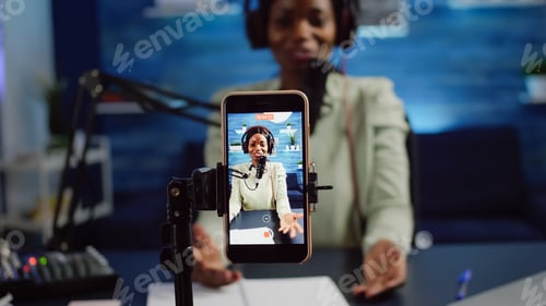 Preview: Close up of smartphone recording black woman influencer looking at camera