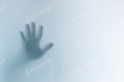 Preview: Defocused scary ghost hands behind a white glass background