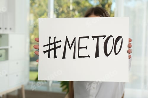 Preview: Woman holding paper with text "#METOO" in office. Problem of sexual harassment at work