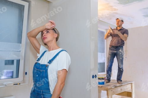 Preview: Workers make repairs in new apartment. Woman and man plaster walls and ceilings