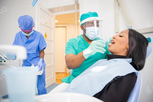 Preview: Dentist visit in a clinic in africa, patient opens her mouth while doctor uses dental tools