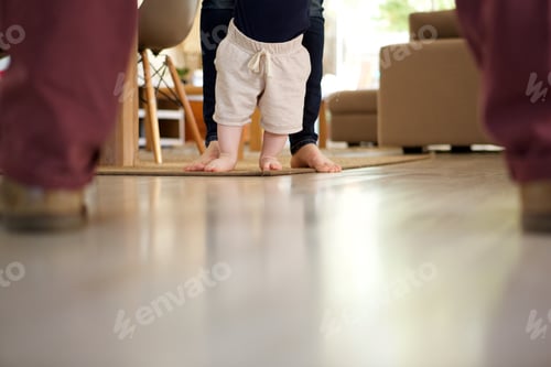 Preview: little baby boy learning to walk with mother help at home