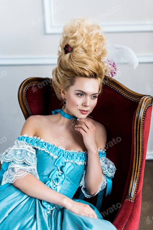 Preview: young victorian woman in blue dress sitting on antique chair