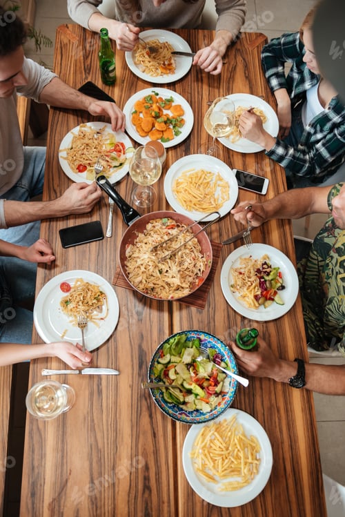 Preview: Top view of people having dinner together while sitting