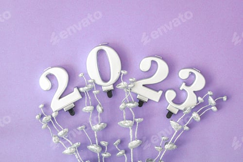 Preview: Lilac Christmas background with numbers 2023 and decor details, flat lay.