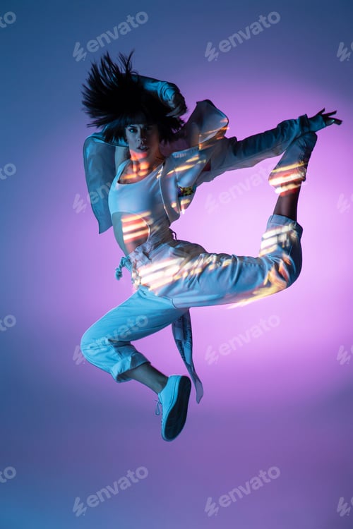 Preview: Energetic dancer jumping and looking at camera