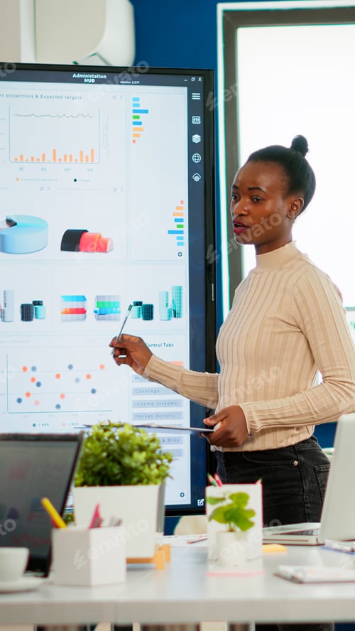 Preview: African american coach giving corporate presentation for businesspeople