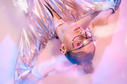 Preview: Stylish woman flaunts holographic fashion in a vibrant futuristic setting