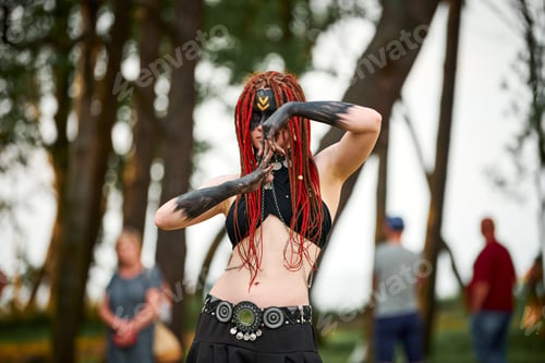 Preview: Mythological dancing girl faun on green lawn in public park outdoor art dancing event
