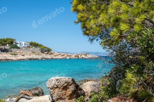 Preview: Greece Agistri island destination Aponisos beach. Rocky beach pine tree clear turquoise sea water.