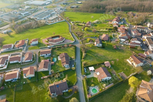 Preview: Aerial view of residential houses in green suburban rural area